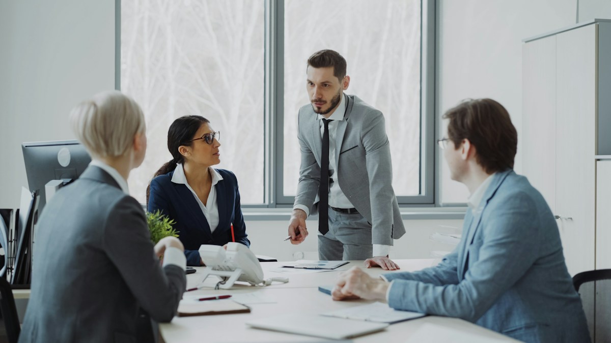 Business professionals discussing ideas around a meeting table